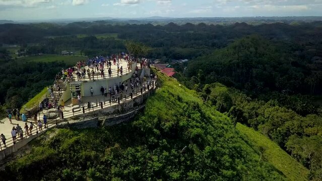 Carmen, Bohol, Philippines - Tourists admire the view from the observatory of the famous Chocolate Hills Complex in Carmen, Bohol, Philippines.