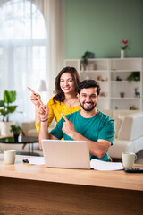 Young Indian couple checking mortgage or loan agreement, financial documents together, using laptop...