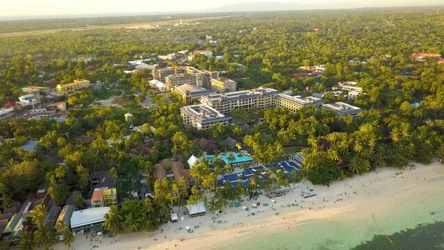 Aerial of Hennan Resort at Alona Beach, in Panglao Island Bohol. Late afternoon with several bancas docked.