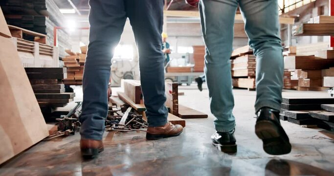 Construction, workers and walking in warehouse building, project development and carpentry trade or craftsman ship with timber. People, industry renovations or labour with safety supervisor