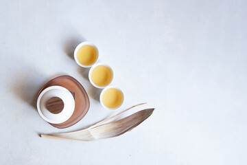 Top view of minimalist tea set with white cups and teapot, copy space