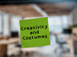 Post note on glass with 'Creativity and Costumes'.