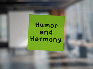 Post note on glass with 'Humor and Harmony'.