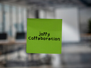 Post note on glass with 'Jolly Collaboration'.