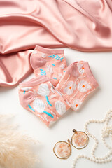 Pastel composition with pink socks on white background