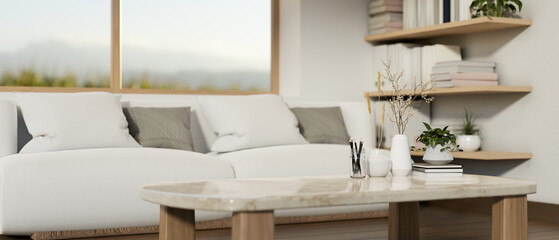 A minimalist neutral white marble coffee table in a contemporary minimalist living room.