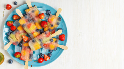 Homemade popsicles with berries and fruits.