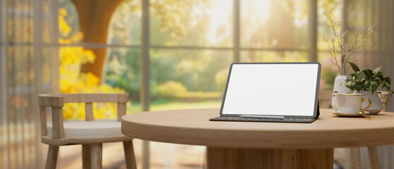 A digital tablet white-screen mockup on a wooden table in a comfortable neutral living room.