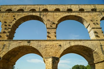 Fotobehang Pont du Gard Pont du Gard famous aqueduct arched bridge close-up view, popular tourist landmark in France