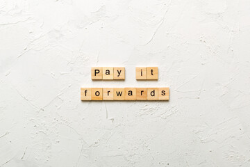 Pay It Forward word written on wood block. Pay It Forward text on cement table for your desing, concept - obrazy, fototapety, plakaty
