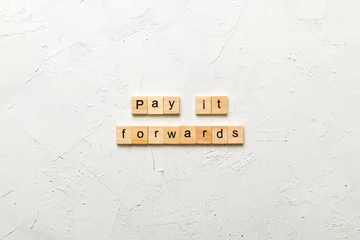 Poster Pay It Forward word written on wood block. Pay It Forward text on cement table for your desing, concept © sosiukin