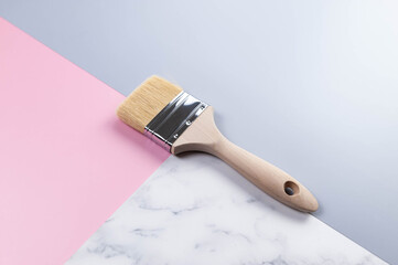 Top view of paint brush on colourful background. Blue, pink and marble background. Pastel colourful wallpaper, marble texture, copy space.