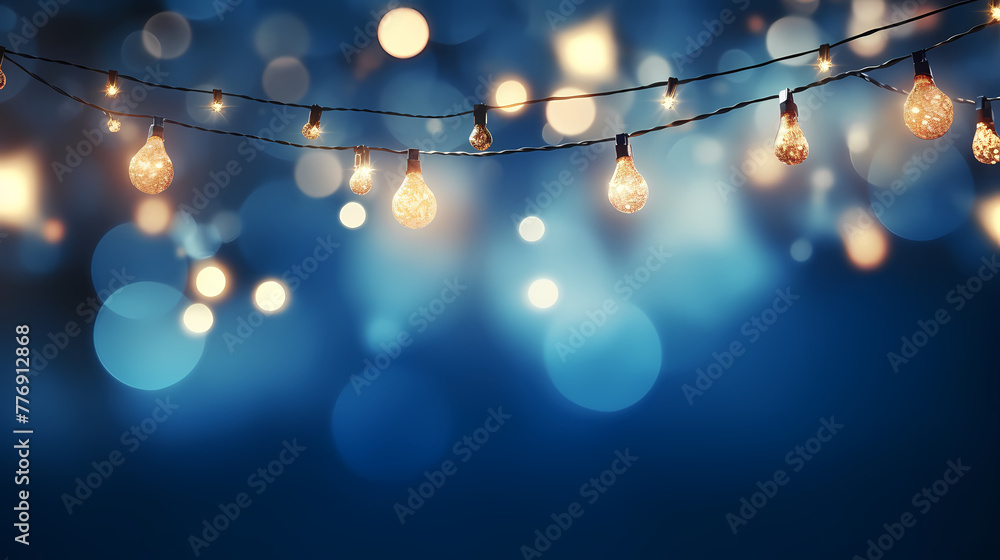 Wall mural Blue Illumination and decoration holiday concept Christmas garland bokeh lights over blue background.