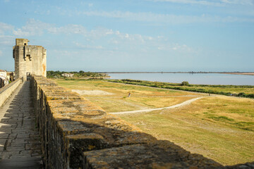Pink salt lake aerial view (Salinas de Aigues Mortes) from medieval ramparts, Camargue, France