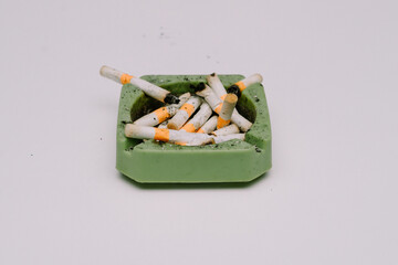 Cigarette butts and ashtrays used by people smoking were placed on white mats