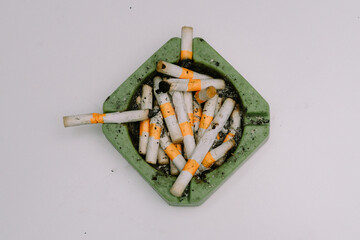 Cigarette butts and ashtrays used by people smoking were placed on white mats