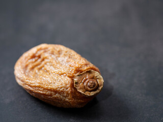 Dried persimmons on a dark background