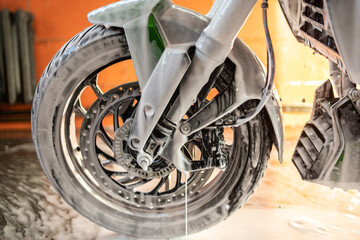 Motorcycle wheel cleaning with foam