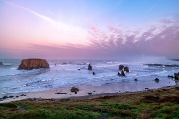 Sunrise at Bandon beach. Surf and sea stacks. Oregon. USA