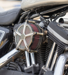 Close-up of a modern motorcycle engine model with frame and exhaust system tuning on a city street.