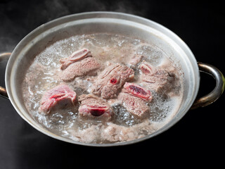 Beef ribs boiled in a pot	