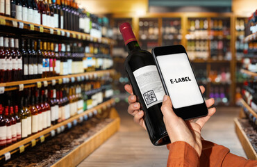 Mockup mobile app for scanning and reading e-labels in retail. Phone with sign e-label on screen scans wine bottle label.