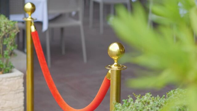 Luxurious velvet and golden rope barrier at an elegant event in 4k slow motion 120fps
