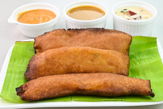 Banana bajji served on a plantain leaf.