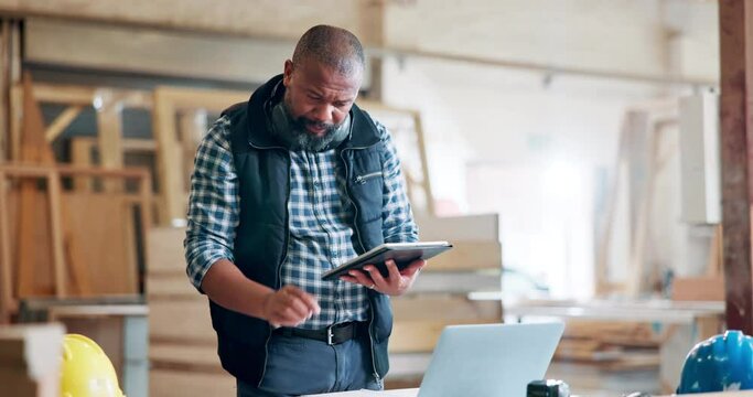 Black man, engineer and workplace with tablet for building ideas, plans and design online. Mature person, work and research as architect in office or startup business for construction project