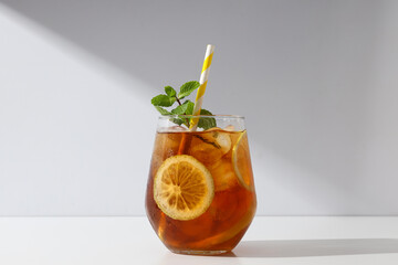 A glass of delicious cold tea on a white background - obrazy, fototapety, plakaty