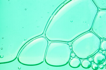 Liquid gel or serum on a screen of microscope blue green  reflected background with bubbles