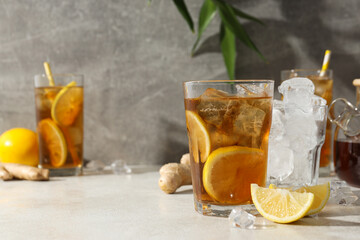 Cold tea with ice, orange slices and mint leaves and ginger