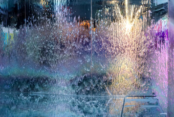 Fototapeta premium Running water on metal surface with multicolor reflections