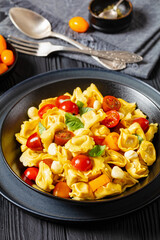 tortellini salad with tomatoes, mozzarella in bowl