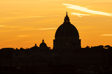 Famous St. Peter dome at sunset. Vatican state. Rome, Italy