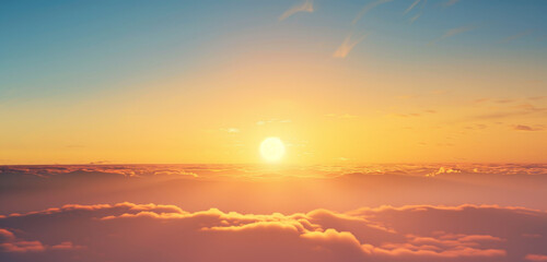 Glorious sunrise over a sea of clouds, with warm golden light.