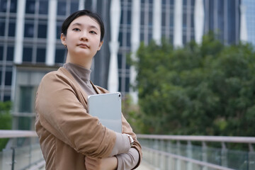 Confident Professional with Tablet in Urban Landscape - 777005272