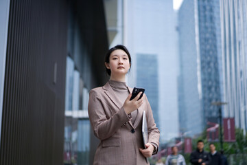 Businesswoman in Cityscape with Smart Device - 777007071