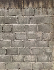 Background image featuring a wall made of concrete bricks.