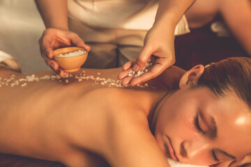 Closeup couple customer having exfoliation treatment in luxury spa salon with warmth candle light...