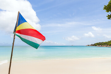 The flag of Seychelles is on the beach on a sunny summer day - 777011660