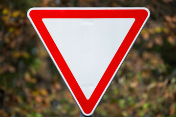 Give way road sign over blurred background