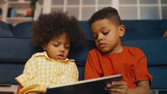 African American children watching video on tablet, development apps for kids