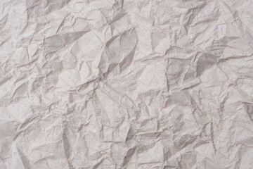 Gray crumpled KI kraft paper texture background. The old wrinkled craft paper backdrop for recycling