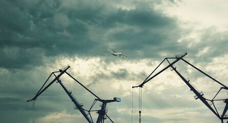 Airplane in the sky, cranes