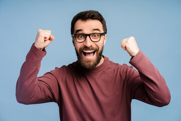 Overjoyed bearded man in glasses looking at camera, win money happy