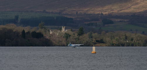 Float plane (sea plane) taxiing ready for take off on a large lake (loch)