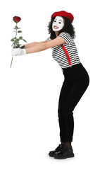 Funny mime with red rose posing on white background