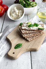 healthy crispy wheat bread with cheese, cucumber on a wooden background. breakfast