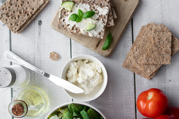 healthy crispy wheat bread with cheese, cucumber on a wooden background. breakfast